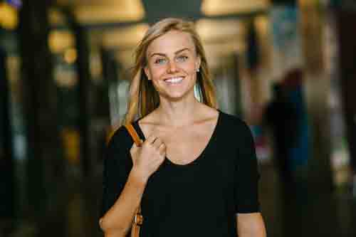 A confident woman walking and smiling