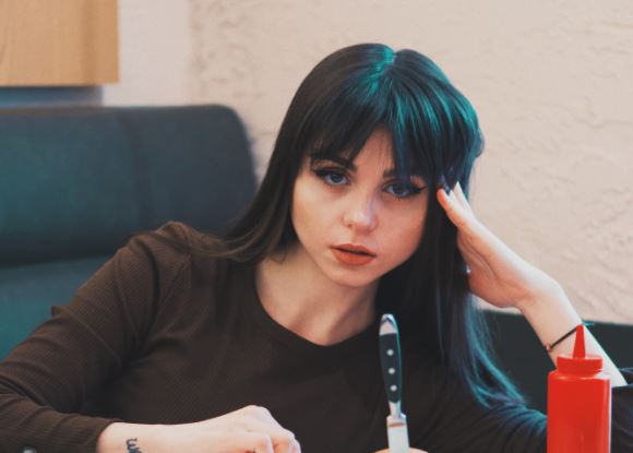 A Ukrainian woman posing with food on the table