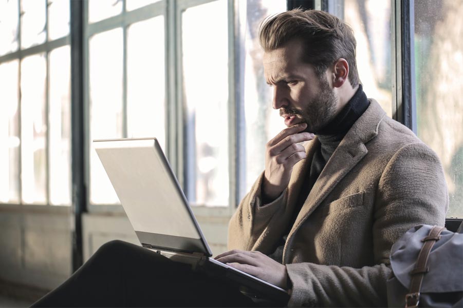 man thinking while looking at computer